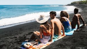 Salon-Prive-Magazine-Article-Four people sitting on the beach